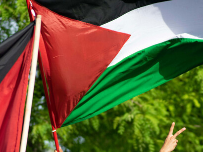 A large Palestinian flag at an anti-war rally