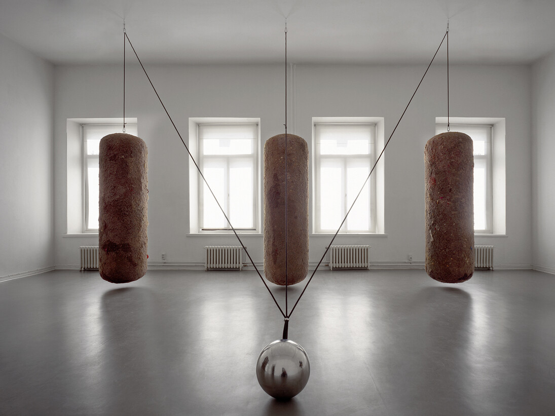 Timo Heino,Gravitation, 1999, House dust, rubber, stainless steel, lead shots, steel ball Ø 30 cm, three dust bales, 210 cm x 60 cm each