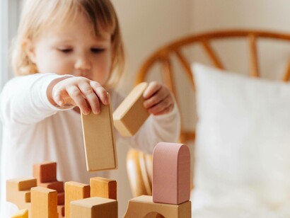 A toddler being creative with their building blocks