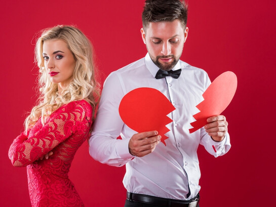 A man and woman facing away, the broken heart highlighting how fear of judgment complicates modern relationships