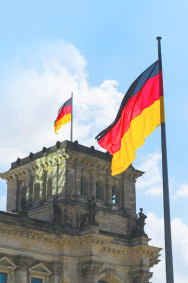 In Berlin, Germany, the German flag stands tall before the Reichstag building
