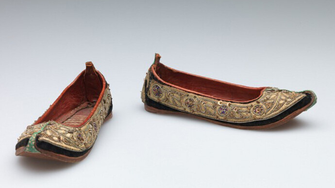 Unknown artist, Indian, Child’s shoes (juttis), late 19th Century, Silk velvet with metallic thread, metal sequin, and stamped metal embellishment, trimmed with leather, Length: 16.5 cm (6 1/2 inches) Gift of Nelson A., Laurence S. and David Rockefeller 56.068