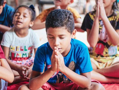 A young boy prays, from São Luís, Maranhão, Brazil