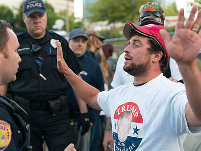 Trump supporter confronts police officers during a political protest