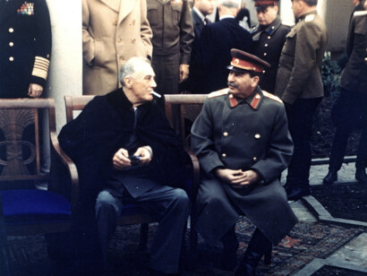 American President Franklin Delano Roosevelt (1882 - 1945) (left) lights a cigarette as he speaks with Soviet General Secretary Joseph Stalin (1878 - 1953) during a break in a photo-op session at the Yalta Conference, 1945, Crimea