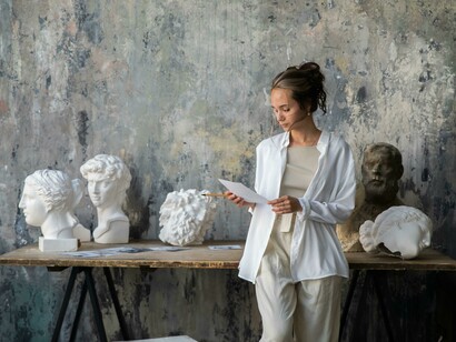 An artist in an art studio, a sculptor working in natural light