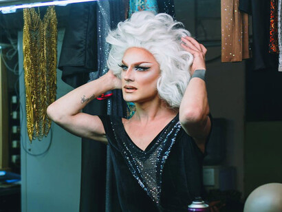 With the final touches complete, the drag queen stands poised, embodying the courage and artistry that will soon take the stage and challenge societal norms