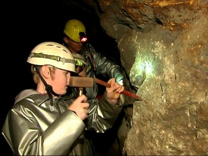 Un giovane visitatore prova il lavoro del minatore