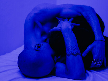 A man is distraught on his bed, holding his pillow; will AI advance to understand emotions and emotional intelligence, as humans feel