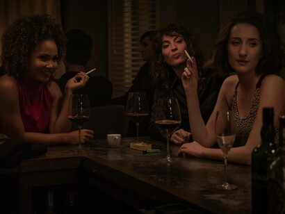The female supportive cast of the TV series “Sweetbitter” having a drink and a smoke