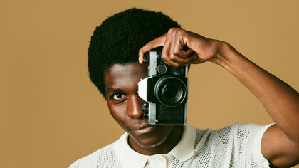 A stylish creator captures the world through his lens, much like the way Death to Stock curates visuals that connect with the cultural zeitgeist