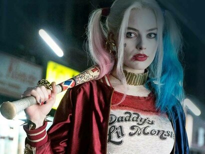 Harley Quinn played by Margot Robbie with a baseball bat looks mad
