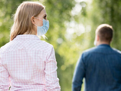 Social distancing in a park during the COVID-19 era: a man and a woman maintaining safe distance