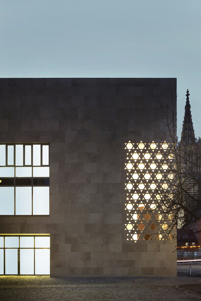 The synagogue's window design allows the light from within the synagogue to illuminate the square at night. Photograph by Christian Richters