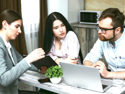 A family meeting with a financial advisor, discussing notes and deciding on their investments