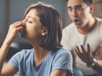 Depressed woman feeling unhappy in a relationship with her boyfriend and ignoring him while he is yelling at her