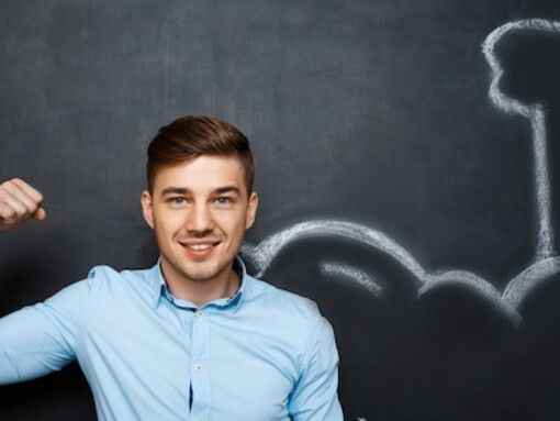 Image of a man with exaggerated muscle arms, symbolizing the concept of goal setting, personal development, and success planning
