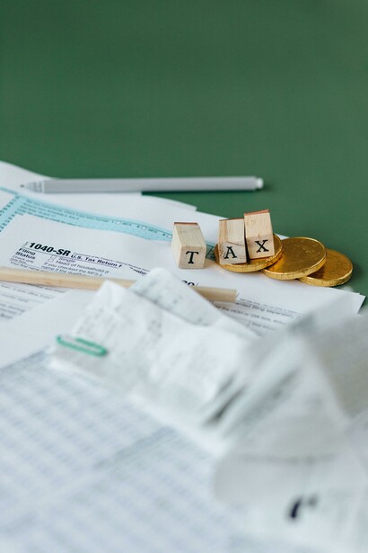 Tax documents on a table with some scattered coins