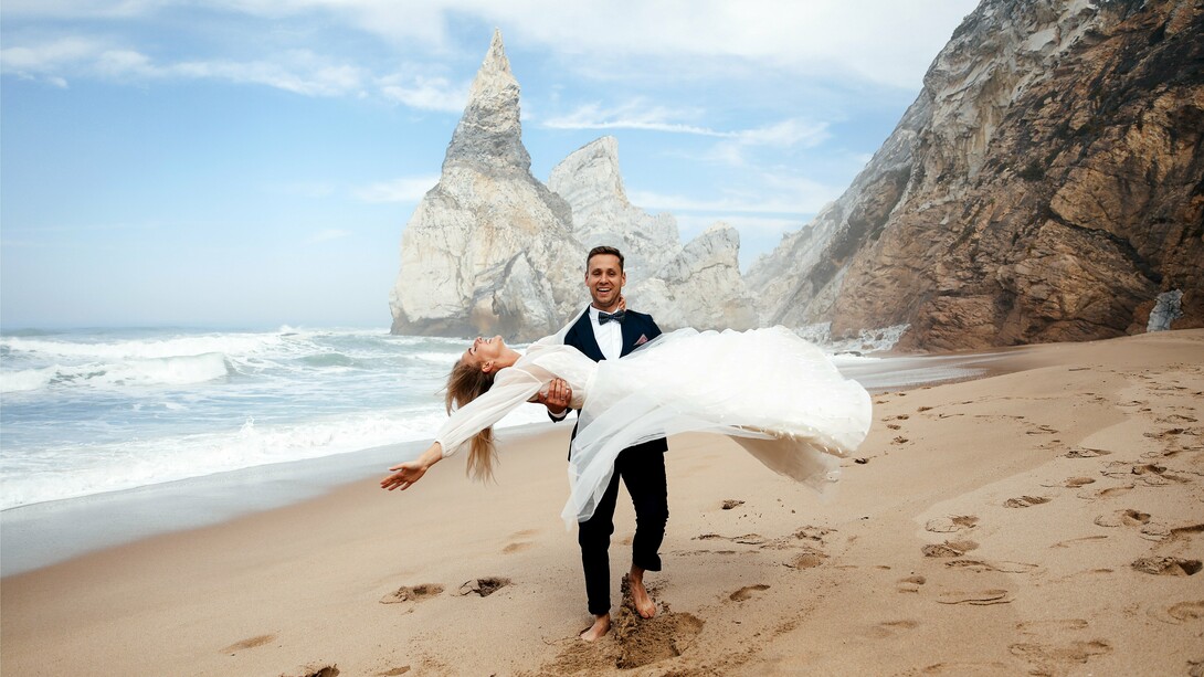 Barefoot on golden sand, this couple proves that the perfect wedding destination is wherever joy meets jaw-dropping scenery