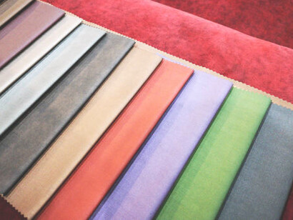 A variety of leather furniture upholstery samples in-store, highlighting eco-friendly fabrics and vegan leather choices that combine sustainability with elegance in home decor