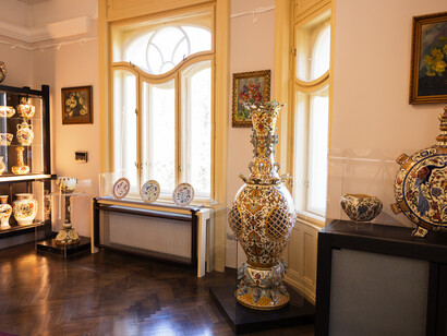 Zsolnay’s eosin-glazed ceramics, showcasing its signature iridescent finish and intricate detailing 