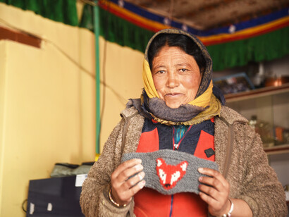 Tanzin Kunzang, homestay host in Kibber, with woollen earmuff she has crafted @ Ashish Kothari