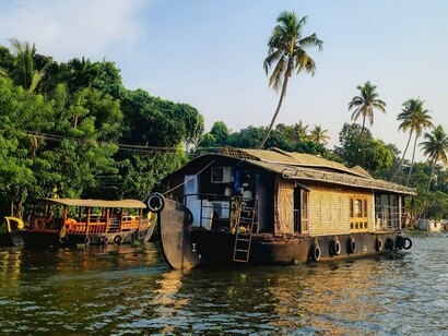 A traditional kettuvallam moving through the backwaters of Alappuzha, Kerala, symbolising a way of life shaped by water, travel, and community