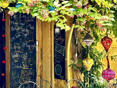 An eye catching cafe entrance adorned with colorful lanterns in Hoi An, Vietnam ©Alma Reyes