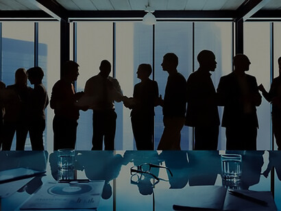 Silhouettes of business professionals engage in discussions, illustrating diplomatic negotiations and fostering international cooperation