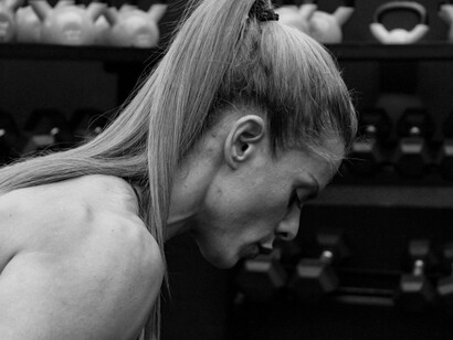 A woman doing strength training, where every rep is a step toward personal growth, proving that true endurance is as much about mindset as it is about muscle