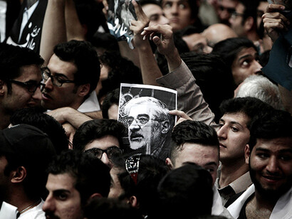 A demonstrator holds a portrait of Green Movement leader Mir Hossein Mousavi, who has been under house arrest since February 2011, Tehran, June 10, 2013. Photo by Behrouz Mehria