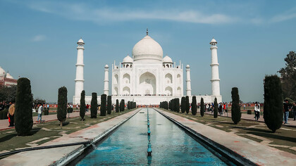 The Taj Mahal is an ivory-white marble mausoleum on the right bank of the river Yamuna in Agra, Uttar Pradesh, India