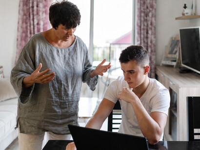 A single mother argues with her teenage son at home, reflecting family tension and emotional conflict