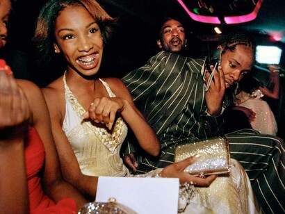 Crenshaw High School girls selected by a magazine to receive “Oscar treatment” for a prom photo shoot take a limo to the event with their dates, Culver City, California, 2001. © Lauren Greenfield