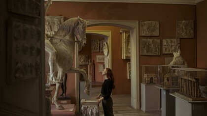 A woman observing artefacts in a museum