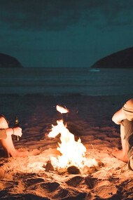 Couple chilling at the bonfire in Tasmania, Australia
