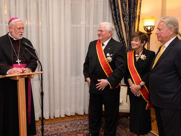 Vatican foreign minister Archbishop Paul Richard Gallagher bestowing the honor of Grand Cross on Gary and Meredith Krupp October 2,  2018 in New York.  Chairman of PTWF Elliot Hershberg is by their side