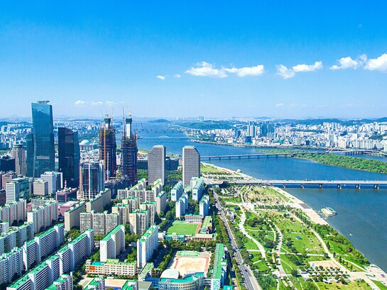 Seoul's expansive skyline stretching beyond the Han River, reflecting a nation that invested in capability before prosperity
