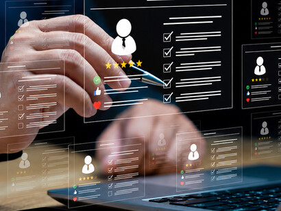 Businessman using AI-powered recruitment software on a laptop to evaluate applicants’ qualifications, scores, and professional profiles through an online hiring system