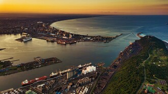 A vibrant aerial view of Durban harbour during sunset, representing Africa’s integration into global trade and financial networks