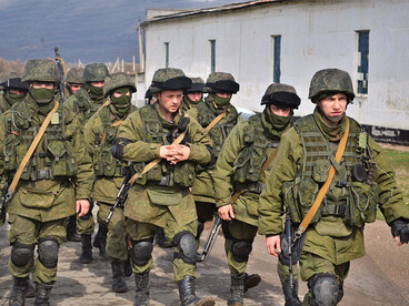 Unmarked armed personnel, widely known as “little green men,” outside the Perevalne military base in Crimea on 9 March 2014 during Russia’s covert military operation in the peninsula