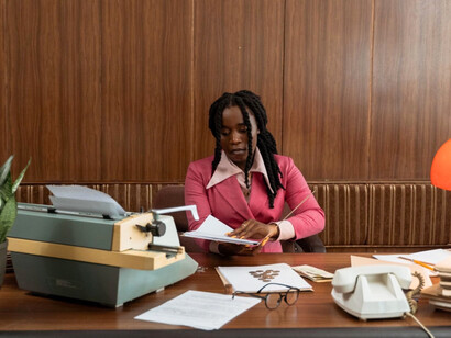 A focused businesswoman immersed in her workday, symbolising the modern African woman's pursuit of professional success