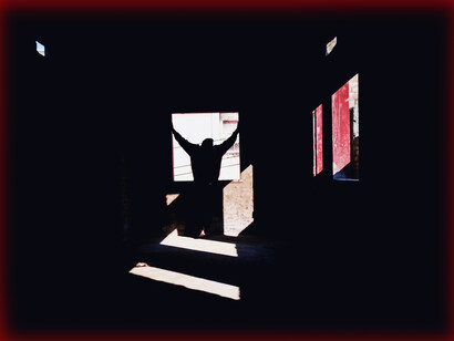 A person standing in a dark room lit by only one window; the author is looking for the new window that can tell him the secret to being a good writer