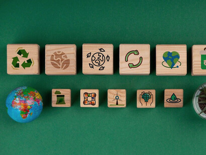 The wooden blocks with eco-friendly icons symbolise the core pillars of modern business, where sustainability is as essential as profit and innovation