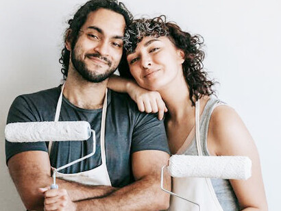 Radiating joy, they share a warm embrace in the heart of their living room, surrounded by the love that fills their home