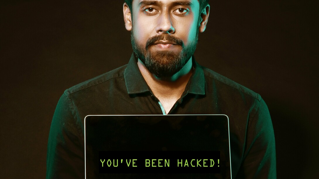Man with a laptop suggesting that 'you have been hacked'