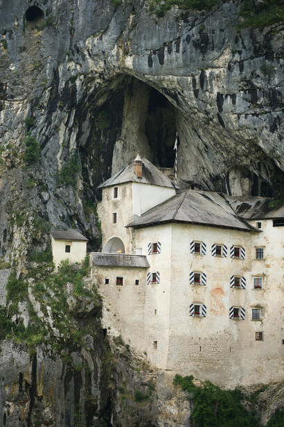 Predjama Castle, located near Postojna in Slovenia, is an ancient fortress built into a dramatic cliffside
