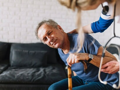 A nurse assisting a man recovering from a stroke in a retirement home