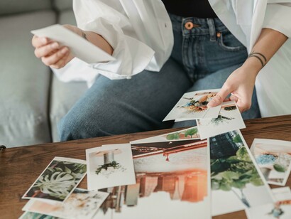 A woman holding Polaroids, showing the excitement of capturing not just faces, but places