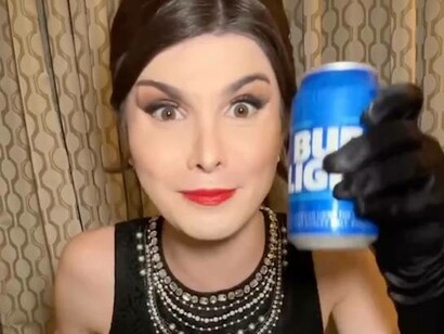 Transgender female Dylan Mulvaney  showcasing her own personalised beer cans of Bud Light